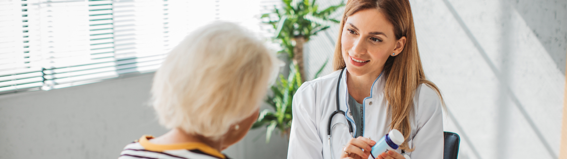 A health professional sits with a senior at a ccrc in Athens, GA.