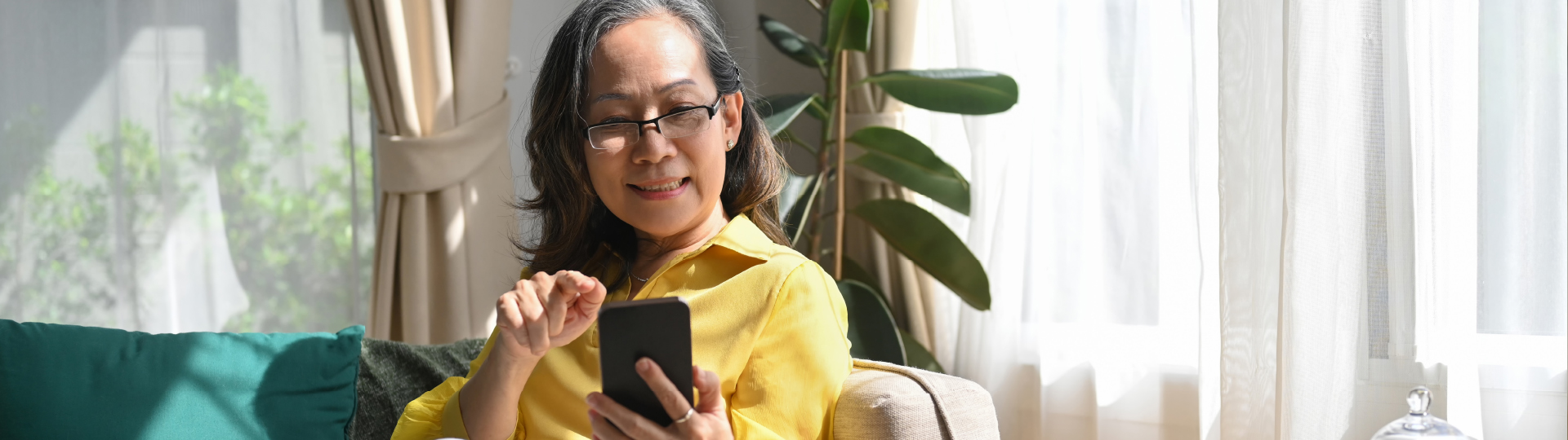 Older woman smiling at phone | Presbyterian Village Athens