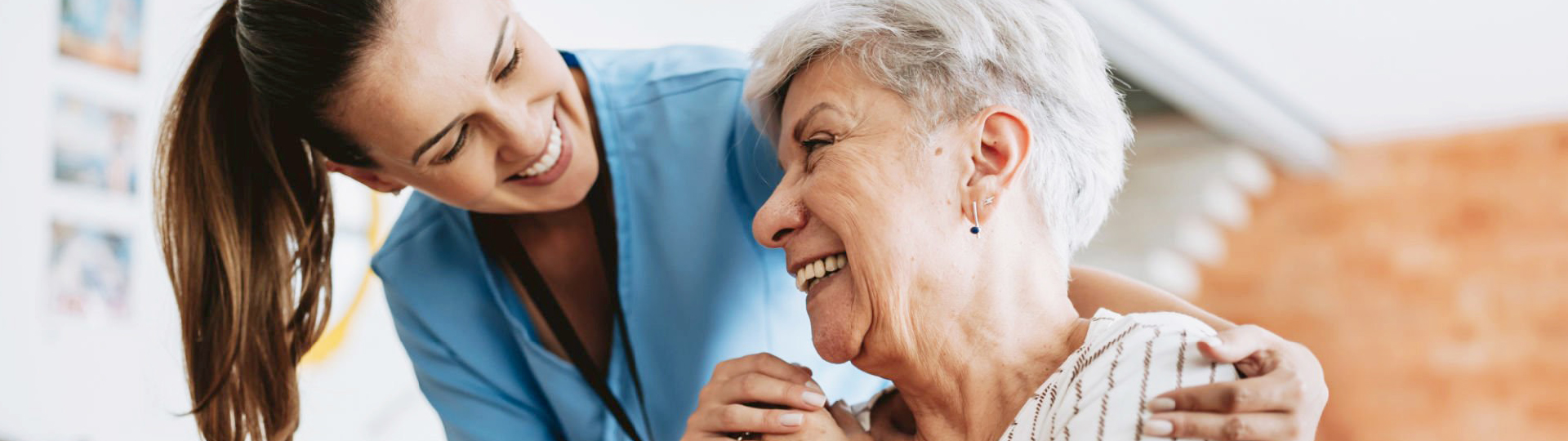 Caregiver smiling with resident | Presbyterian Village Athens