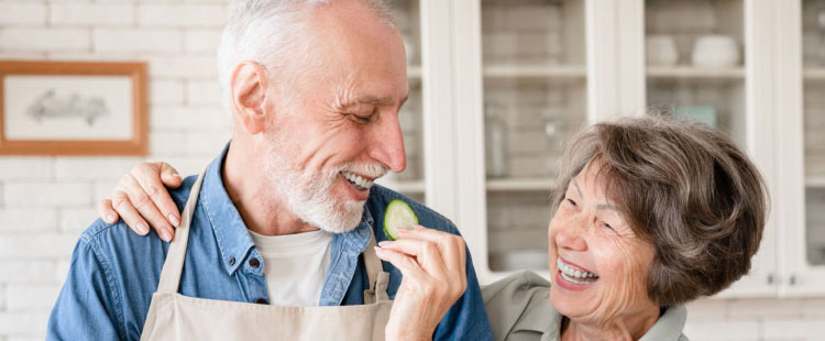 A senior man and woman enjoy each others' company.