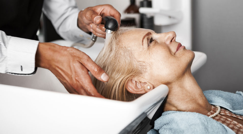 Older woman getting her hair washed in a salon | Presbyterian Village Athens