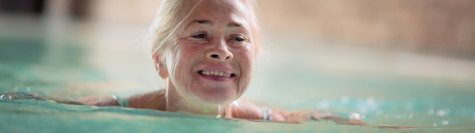 A senior woman swims in a beautiful pool in Athens, GA.